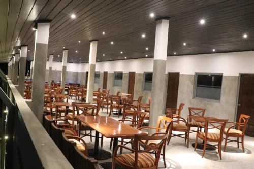 a row of tables and chairs in a restaurant at Tangalle Rest House in Tangalle