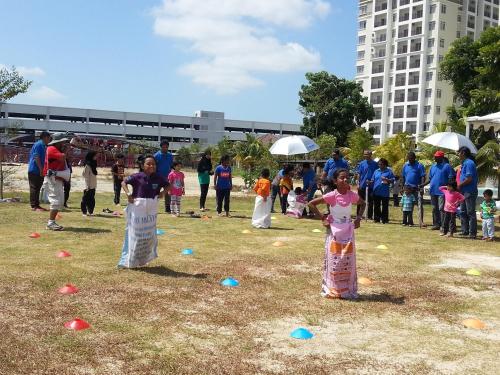 a group of people standing in a field at Bayou Lagoon Park Resort in Melaka