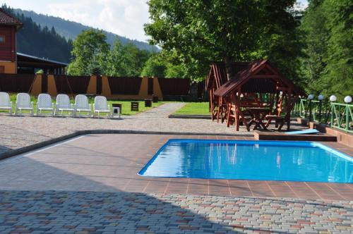 a small swimming pool with chairs and a playground at Extreme in Zhdenievo