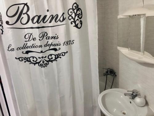 a bathroom with a shower curtain and a sink at Hotel Koldum in Litvínov