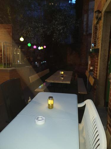 a white table with a candle on top of it at Pension Valeria in Plauen