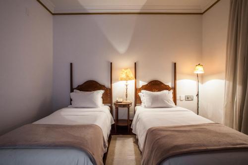 Кровать или кровати в номере Hotel Solar do Rosário