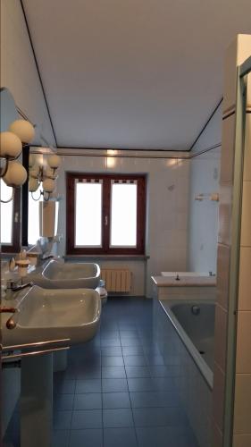 a bathroom with four sinks and a tub at VILLA MERY in Torri del Benaco