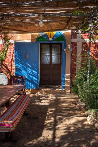 a door to a building with a bench in front of it at Ferme D"Hote Lala Fatima in Aïn Leuh