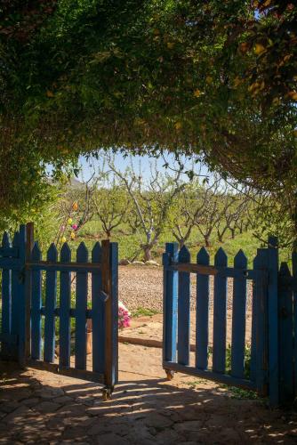 a blue gate in front of a field at Ferme D"Hote Lala Fatima in Aïn Leuh