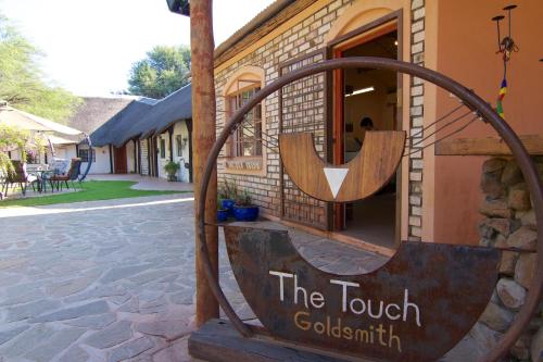 a sign that reads the tavern colonial in front of a building at Kashana Namibia in Omaruru