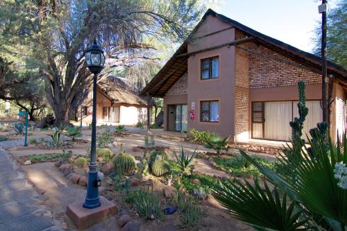 a house with a street light in front of a garden at Kashana Namibia in Omaruru