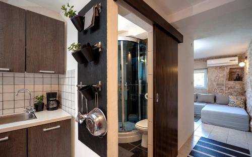 a bathroom with a sink and a toilet in a room at Heritage Stone House Retreat -Free parking in Stari Grad