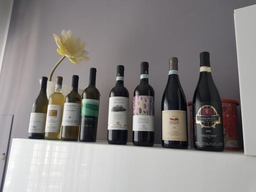a bunch of wine bottles sitting on a shelf at Appartamento Saretta in Asti