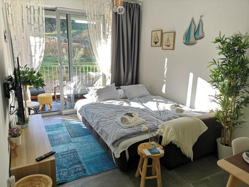 a bedroom with a bed with a blue rug at Romana Dream apartment in Vrsar