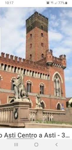 a building with a statue in front of it at Appartamento Saretta in Asti