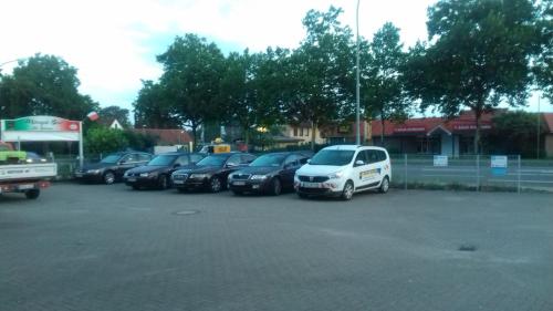 a row of cars parked in a parking lot at Hotel Apartments 73 - Serviced Apartments in Neu Wulmstorf