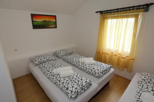 a living room with two beds and a window at Teo-Sport in Cerovac