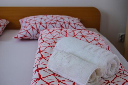 a bed with two towels and pillows on it at Teo-Sport in Cerovac
