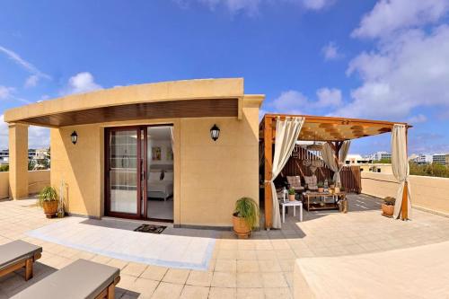 a patio with a pergola and a house at CENTER Penthouse - MEDIEVAL Town 10'- BEACH 2' in Rhodes Town