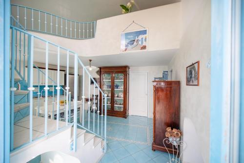 a staircase in a home with blue tile floors at Casa Athina in Procida