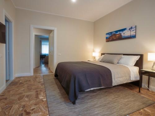a bedroom with a large bed and two lamps at SILIA HOUSE Napoli Centro in Naples