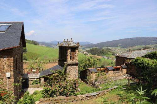 an old building with a tower on a hill at Casa Rural Norita - Adults only in Lourenzá