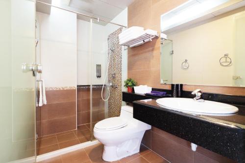 a bathroom with a toilet and a sink and a shower at 36 Lighthouse in Hualien City