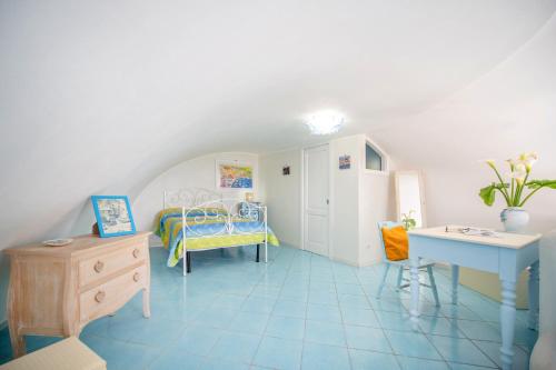 a room with a bedroom with a bed and a desk at Casa Athina in Procida