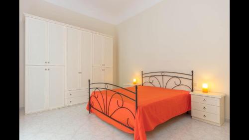 a bedroom with a bed with two candles on it at Spacious modern and cozy apartment in Trapani