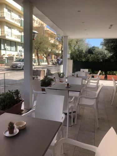 a group of tables and chairs on a patio at Pensione Elena in Misano Adriatico