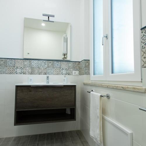 a bathroom with a sink and a mirror at Villa Aurora Mondello Addaura in Mondello