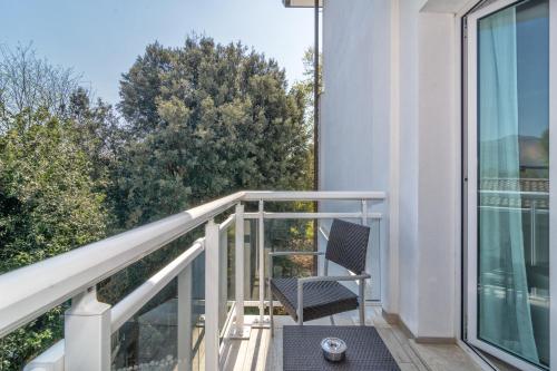 a chair on the balcony of a house at Hotel Central Park in Marina di Pietrasanta