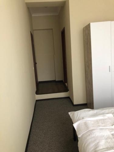 a bedroom with a bed and a door to a closet at El Mundo Apartments in Lviv