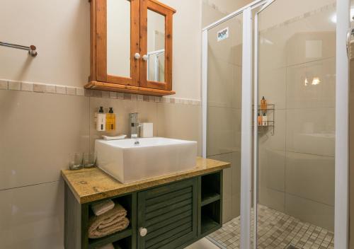 a bathroom with a sink and a shower at Caledon 23 Country House in George