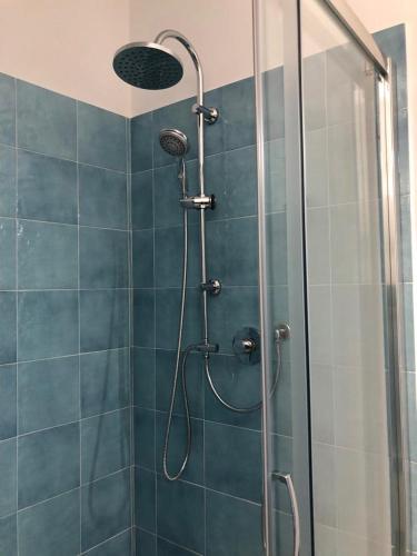 a shower with a shower head in a bathroom at Appartamenti Milù - Milù Holidays in La Maddalena