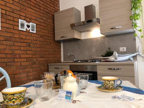 a kitchen with a table with two cups on it at Appartamenti Milù - Milù Holidays in La Maddalena