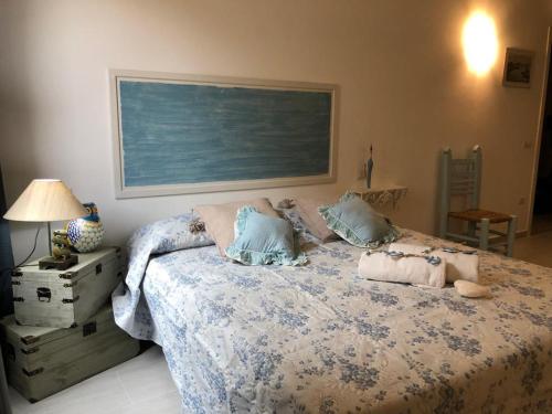 a bedroom with a bed with pillows on it at Appartamenti Milù - Milù Holidays in La Maddalena