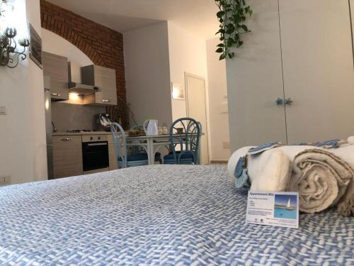 a bedroom with a bed with a sign on it at Appartamenti Milù - Milù Holidays in La Maddalena