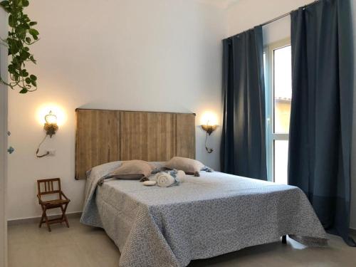 a bedroom with a bed and a large window at Appartamenti Milù - Milù Holidays in La Maddalena