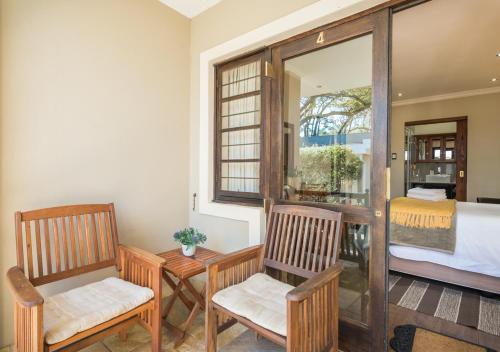 a room with two chairs and a bed and a window at Caledon 23 Country House in George