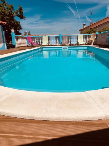 a large swimming pool with blue water at Fatima Belavista & Pool in Fátima