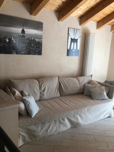a couch in a living room with a city at Mansarda 5 terre in Monterosso al Mare