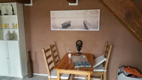 a dining room with a wooden table and chairs at Haus Speck 5 in Kargow