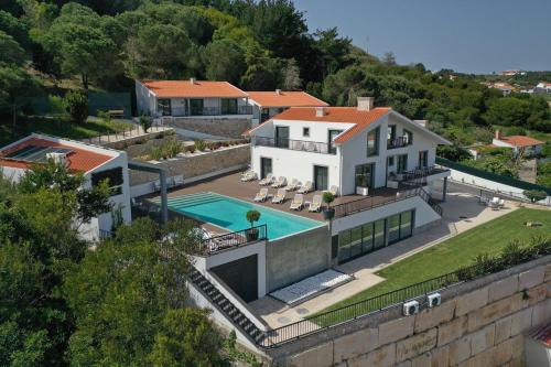 an aerial view of a house with a swimming pool at Hillside House Suites & Spa in Foz do Arelho