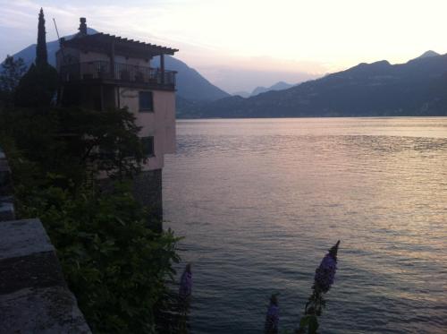 a building on the side of a body of water at La Perla del Lago di Como - CIR O97O67 in Perledo