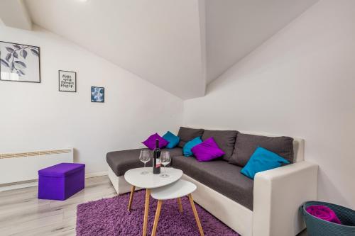 a living room with a couch and a table at Bella Central apartment in Rijeka
