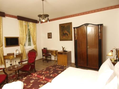 a hotel room with a bed and a table and chairs at Hotel Puntijar in Zagreb