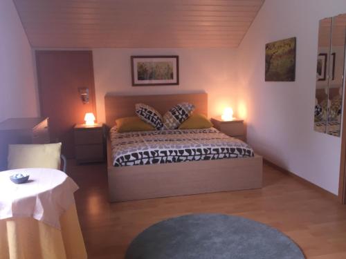 a bedroom with a bed with two lights on it at Queen Guest Room in Mont-sur-Rolle
