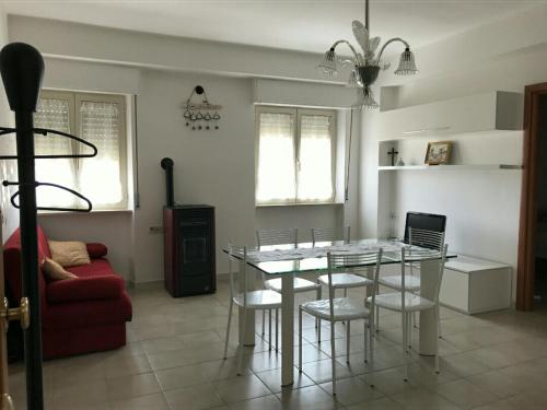 a living room with a table and chairs and a couch at Grattacielo alla Stazione in Sannicandro Garganico