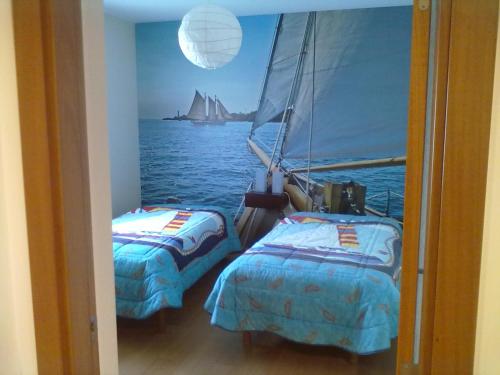 two beds on a boat with a view of the ocean at Ericeira - Apartment with Patio - Horizonte Mar in Ericeira