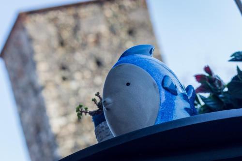 a blue bird sitting on top of a hat at GF Holiday Suite in Varazze