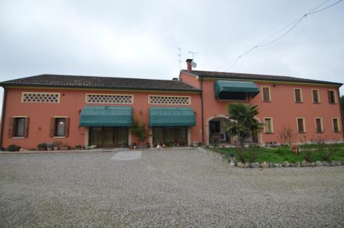 a large red building with blue awnings on it at Agriturismo I Marzemini in Legnaro