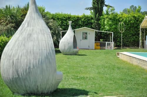 two large plastic bags in a yard with a pool at Cevoli Country Resort in Lari