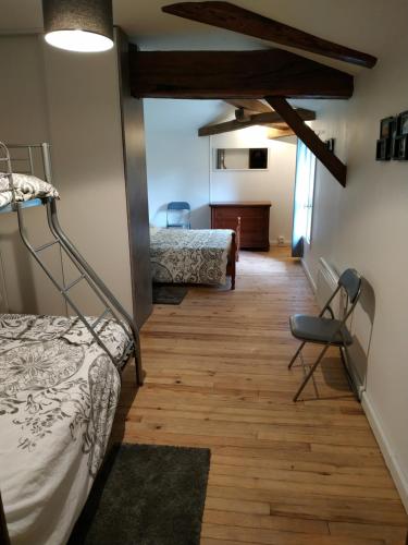 a room with two bunk beds and a desk at l'Airial de Nahouns in Sabres